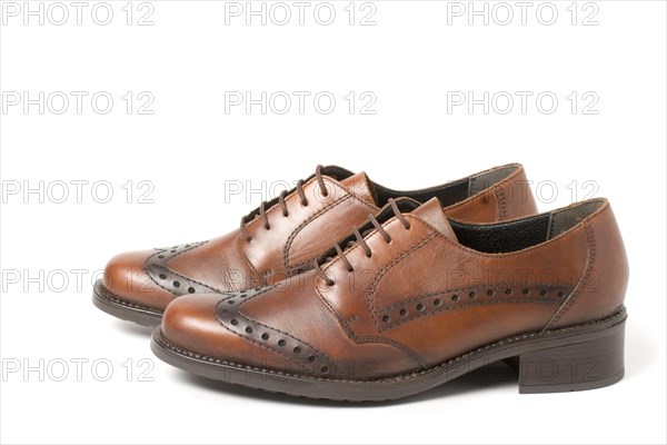 Two brown shoes isolated on white background