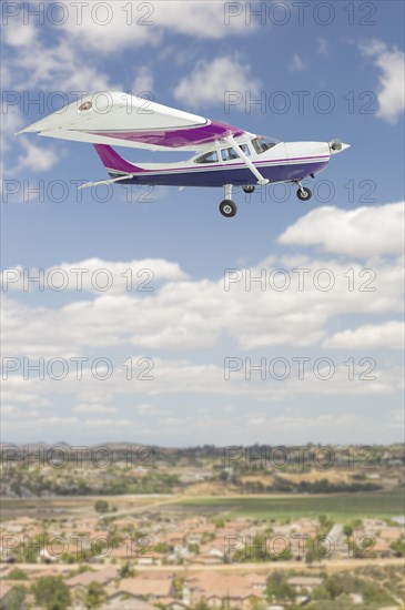 The cessna 172 single propeller airplane flying in the sky