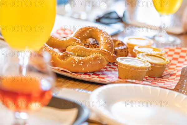 Abstract of small glass of micro brew beers and warm pretzels on bar