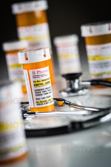 Several non-proprietary medicine prescription bottles abstract with stethiscope