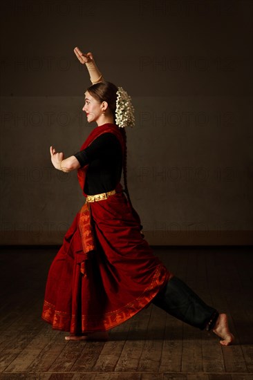 Young woman in sary dancing classical traditional indian dance Bharat Natyam