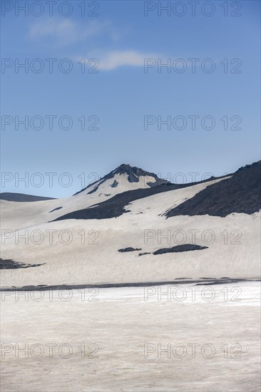 Barren hilly volcanic landscape of snow and lava fields