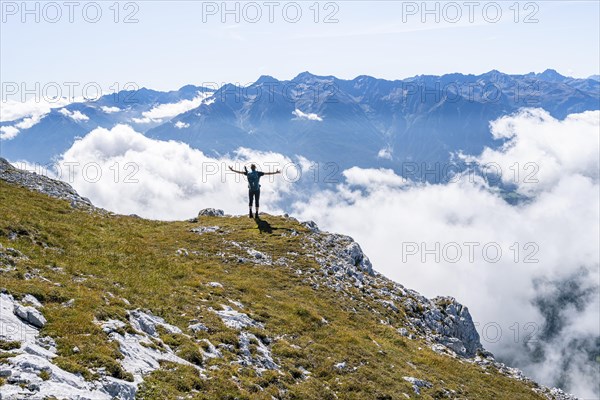 Hiker above the clouds