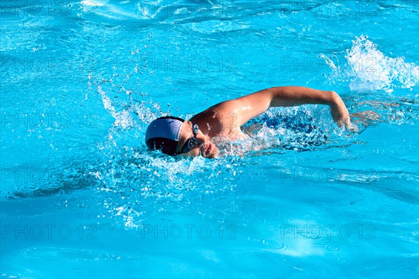 Athletic Man swimming in the pool