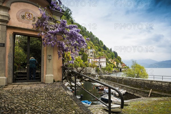 Small boat harbour and colourful villas on the lakeside