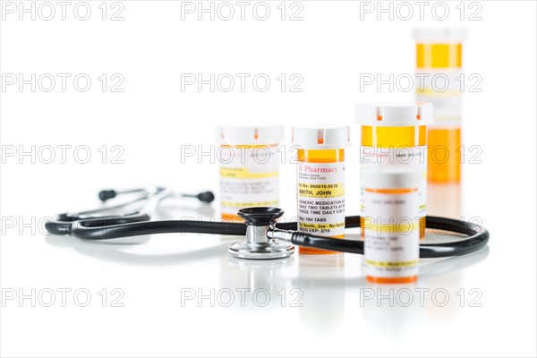 Group of non-proprietary medicine prescription bottle with stethoscope isolated on a white background