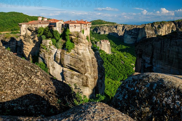 Monastery of Varlaam monastery and Monastery of Rousanou in famous greek tourist destination Meteora in Greece on sunset with scenic scenery landscape