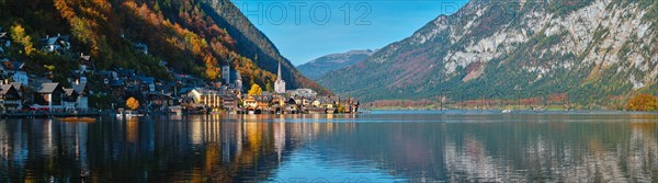 Panorama of Austrian tourist destination Hallstatt village on Hallstatter See in Austrian alps in autumn with traditional autstrian boat