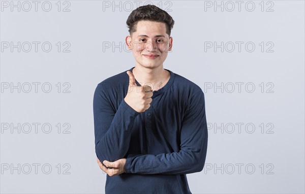 Smiling man showing ok gesture looking at camera