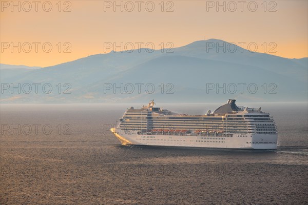 Cruise ship in Aegean sea on sunset. Mykonos island