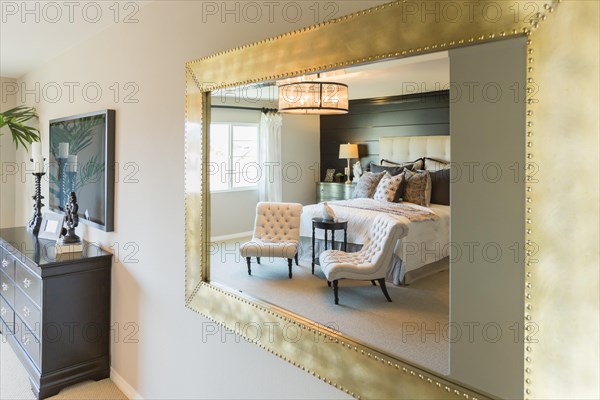 Beautiful bedroom reflection in decorative mirror
