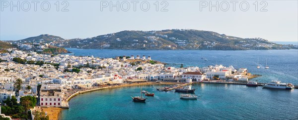 View of Mykonos town Greek tourist holiday vacation destination with famous windmills