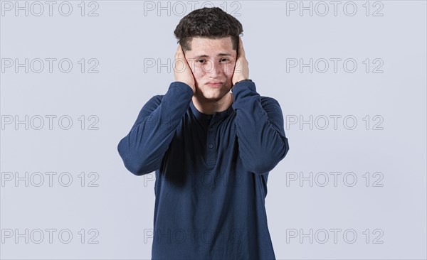 A guy covering his ears