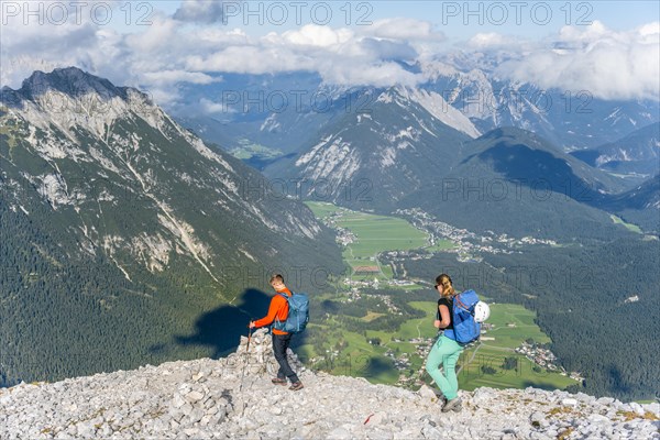 Hiker in front of mountain landscape