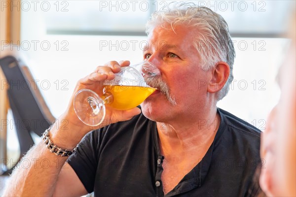 Handsome man tasting A glass of micro brew beer