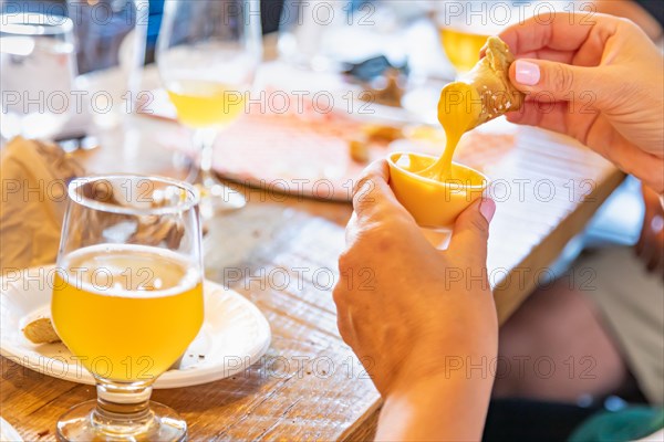 Woman enjoys warm pretzels and micro brew beer
