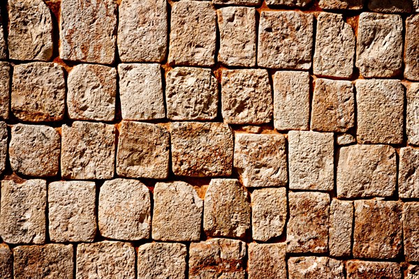 Texture of stone wall of ancient Mayan pyramids in Uxmal