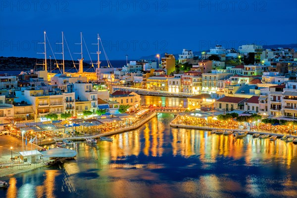 Beautiful Agios Nikolaos town on lake Voulismeni at night. Lasithi region of Crete island