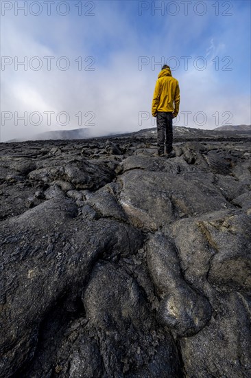 Tourist standing on petrified lava