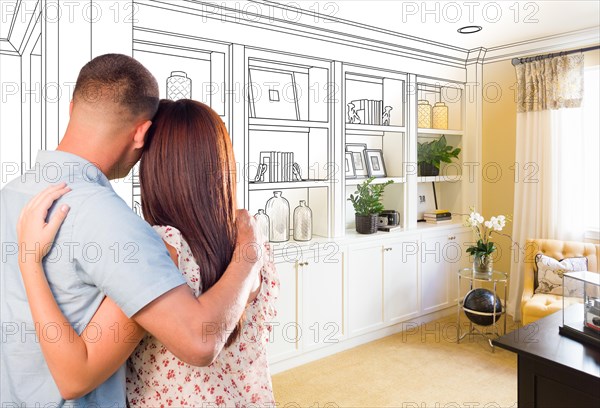 Young military couple facing custom built-in shelves and cabinets design drawing gradating to finished photo