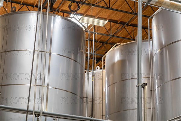 Large beer brewery fermentation tanks in warehouse