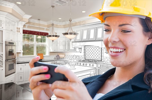 Female contractor using smart phone over kitchen drawing gradating to photo