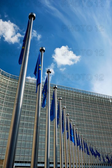 Helplessly drooping EU European Union flags with the European Comission building in Background Brussles