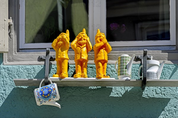 Three dwarfs at the window sill