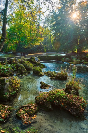 Munich English garden Englischer garten park and Eisbach river with artificial waterfall