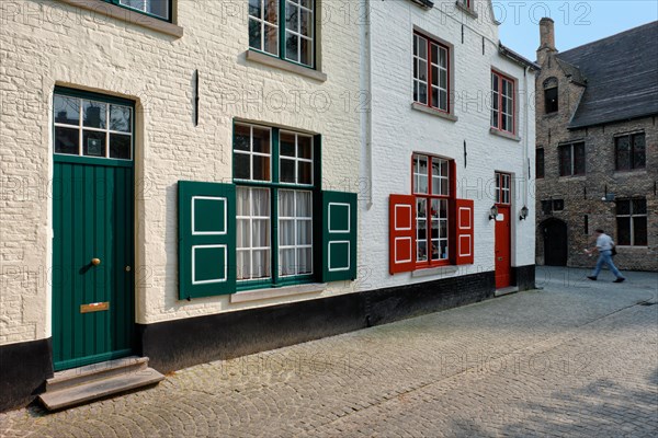 Door and window of an old house and street with motion blurred man