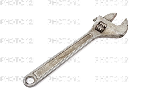 Old adjustable spanner isolated on white background