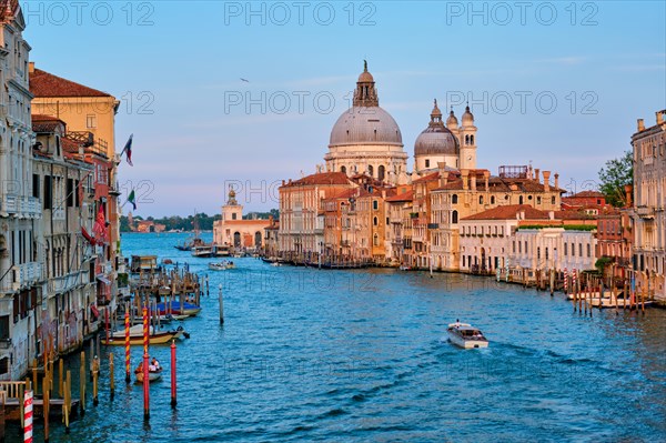 Panorama of Venice Grand Canal with boats and Santa Maria della Salute church on sunset from Ponte dell'Accademia bridge Venice