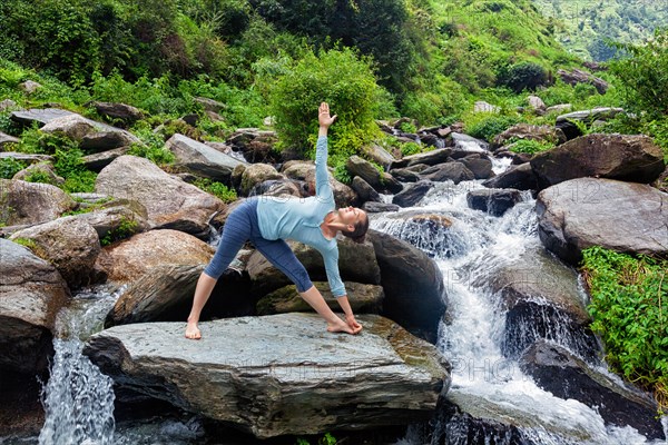 Woman doing Ashtanga Vinyasa yoga asana Utthita trikonasana