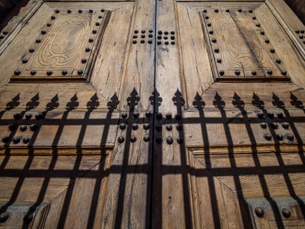 Shadow from a fence at the church gate