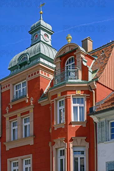 Red classicist facade with oriel