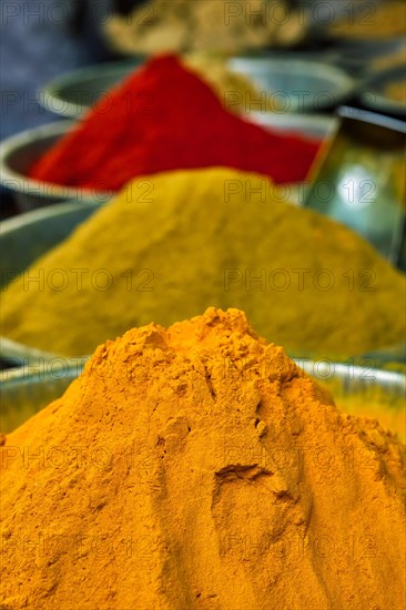 Turmeric curcuma powder and chili powder in spices market in India. Sardar Market