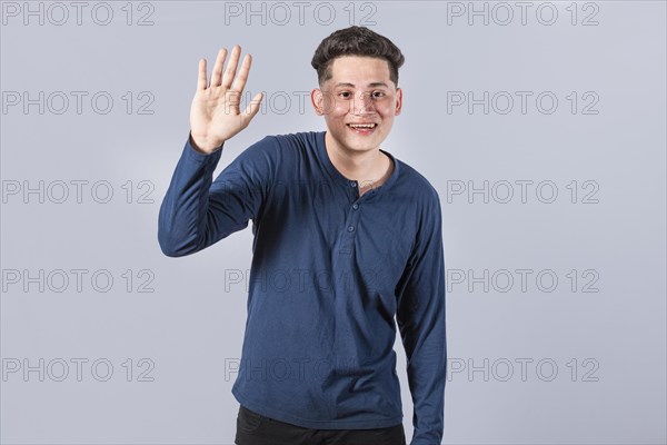 Man raising arm and waving friendly