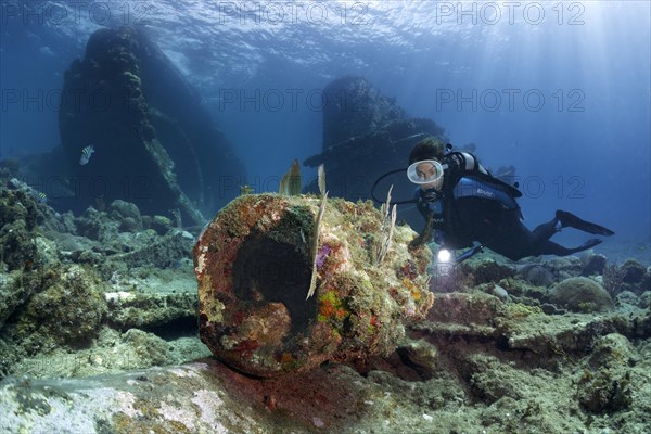 Diver looking at muzzle of gun barrel