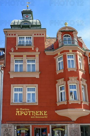 Red classicist facade with bay window