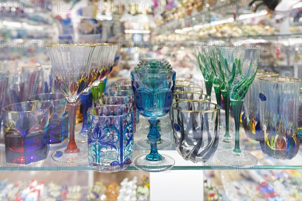 Colourful drinking glasses made in Murano on display in a shop in Venice