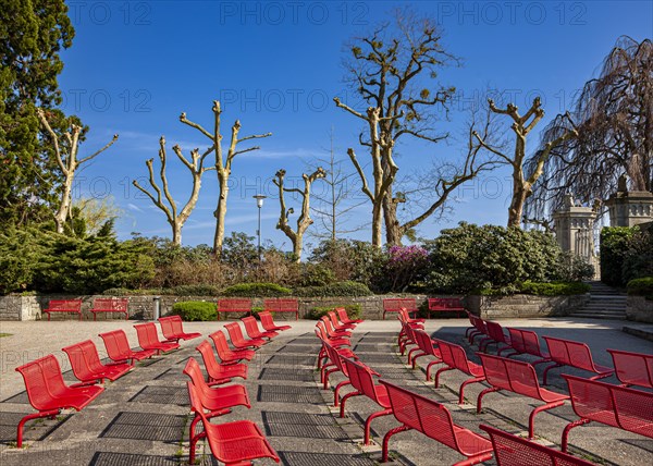 Row of red chairs in a park in Langenargen