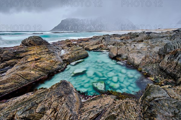 Rocky coast of fjord of Norwegian sea in winter. Lofoten islands