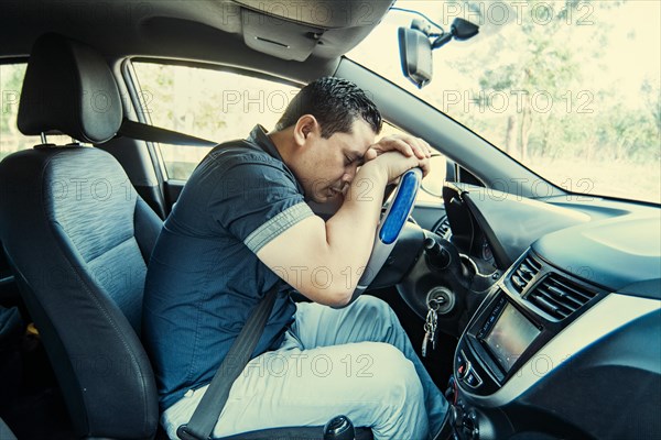 A tired driver asleep at the wheel