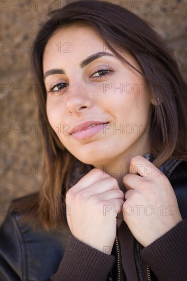 Beautiful meloncholy mixed-race young woman portrait outside