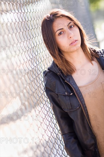 Beautiful meloncholy mixed-race young woman portrait outside