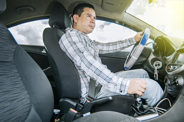 A happy man driving a car