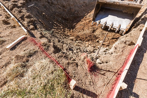 Small bulldozer digging in yard for pool installation