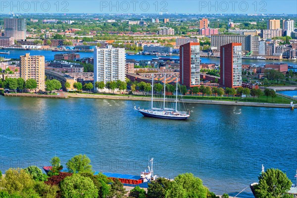 View of Rotterdam city and Nieuwe Maas river with sailing vessel from Euromast