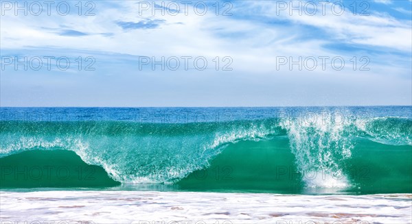 Big wave in ocean with blue sky