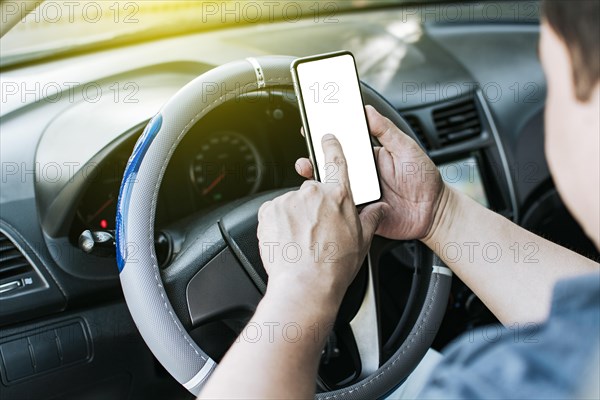 Close up of driver hands using his phone